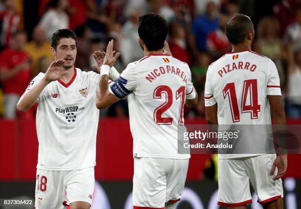 Sergio Escudero and Nicolas Pareja of Sevilla celebrate after scoring a goal during the UEFA Champions League play-off match between Sevilla and...