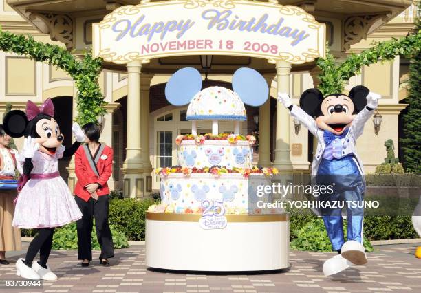 Disney characters Mickey and Minnie Mouse celebrate Mickey's 80th birthday with guests who were born on November 18, at a Disneyland hotel in...