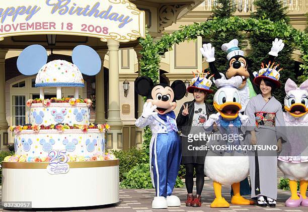 Disney character Mickey Mouse celebrates his 80th birthday with guests who were born on November 18, at a Disneyland hotel in Urayasu, in Chiba...