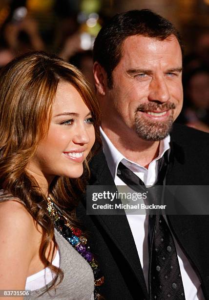 Actress/Singer Miley Cyrus and Actor John Travolta arrive at the premiere of Walt Disney Animation Studios' "Bolt" held at the El Capitan Theatre on...