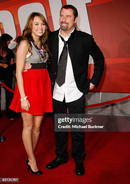 Actress/Singer Miley Cyrus and Actor John Travolta arrive at the premiere of Walt Disney Animation Studios' "Bolt" held at the El Capitan Theatre on...