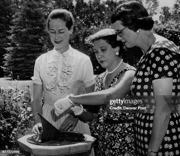 Mrs. Francis M. Bell checks her watch by a sun dial at St. Anne's Convalescent Home during a planning session for a garden tour to benefit the home....