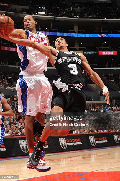 George Hill of the San Antonio Spurs has his shot blocked by Marcus Camby of the Los Angeles Clippers at Staples Center on November 17, 2008 in Los...