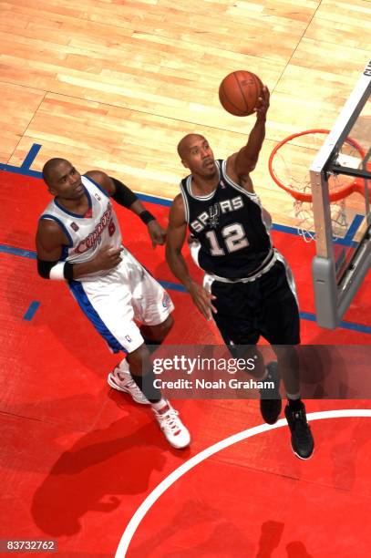 Bruce Bowen of the San Antonio Spurs goes up for a layup while Cuttino Mobley of the Los Angeles Clippers looks on during their game at Staples...