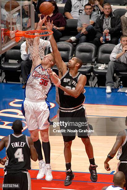 Chris Kaman of the Los Angeles Clippers has his shot contested by Tim Duncan of the San Antonio Spurs at Staples Center on November 17, 2008 in Los...