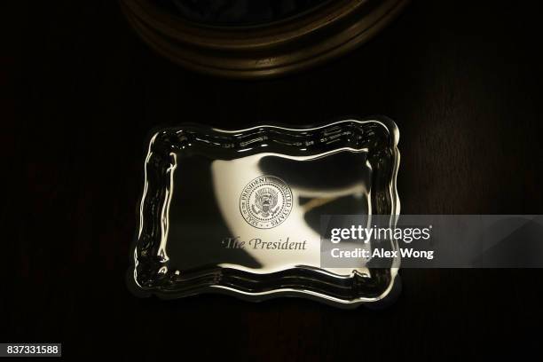 Tray engraved with the presidential seal is placed on a stand in the West Wing lobby of the White House August 22, 2017 in Washington, DC. The White...