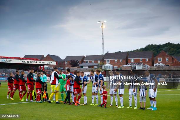 The two teams greet each other prior to of the Carabao Cup Second Round match between Accrington Stanley and West Bromwich Albion at Wham Stadium on...