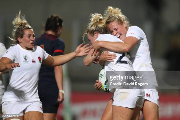 Megan Jones of England celebrates with teammate Amber Reed after scoring her team's second try during the Women's Rugby World Cup 2017 Semi Final...