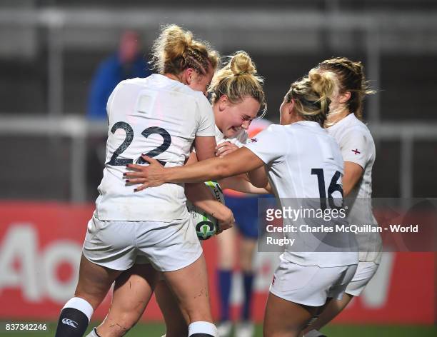 Megan Jones of England is mobbed by team mates after scoring the final try of the game during the Womens Rugby World Cup semi-final between England...