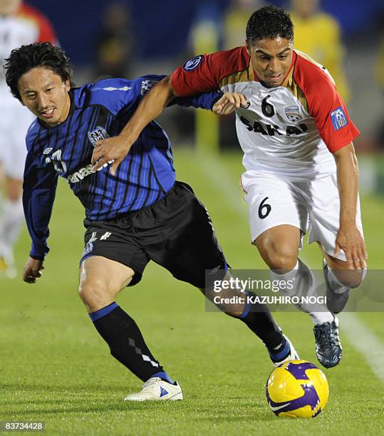 Australia's Adelaide United defender Jose de Abreu Oliveira and Japan's Gamba Osaka midfielder Hideo Hashimoto fight for the ball during their Asian...