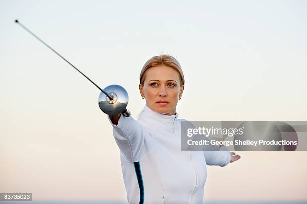 woman praticing her fencing technique - fioretto sport foto e immagini stock