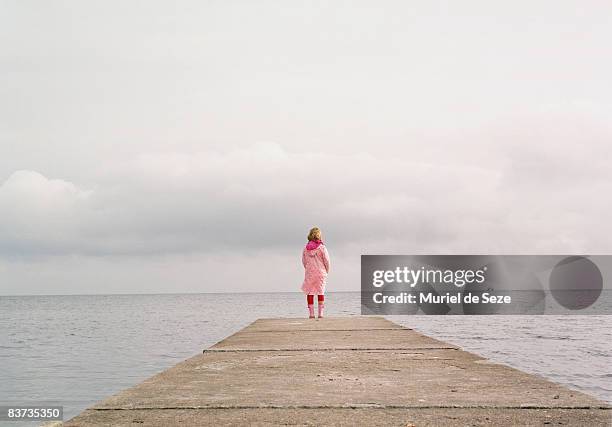 girl standing on pier - girl waiting stock pictures, royalty-free photos & images