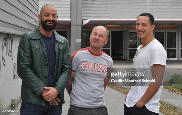 Anton Noori, Roland Dueringer and Laurence Rupp pose during a set visit for 'Cops' at Dusika Stadion on August 22, 2017 in Vienna, Austria.