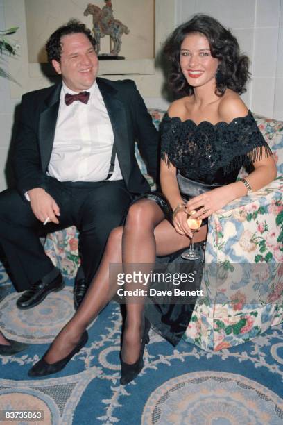 Actress Catherine Zeta-Jones with producer Harvey Weinstein at a party at the Hyde Park Hotel, for the UK release of 'Hot Shots', 10th November 1991.