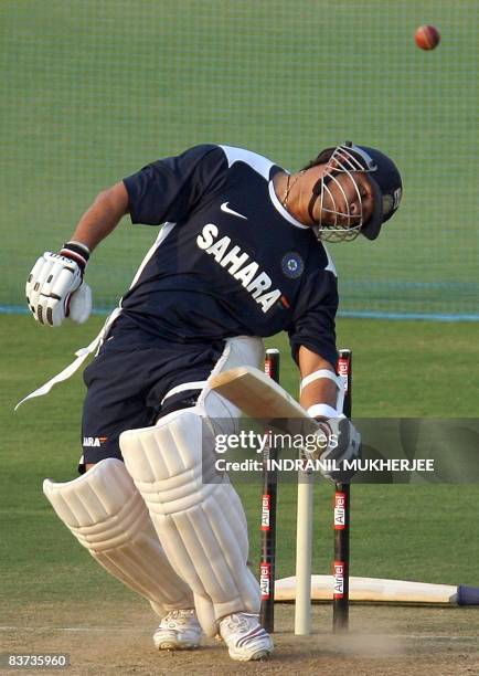 Indian cricketer Sachin Tendulkar evades a rising delivery from unseen bowling coach Venkatesh Prasad during a training session at The VCA cricket...