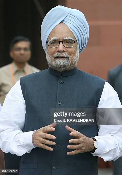 Indian Prime Minister Manmohan Singh speaks to the media outside Parliament house in New Delhi on October 17, 2008 on his arrival to attend the...