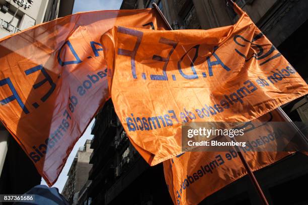 Demonstrators wave flags during a protest in Buenos Aires, Argentina, on Tuesday, Aug. 22, 2017. Union groups protested Argentinean President...