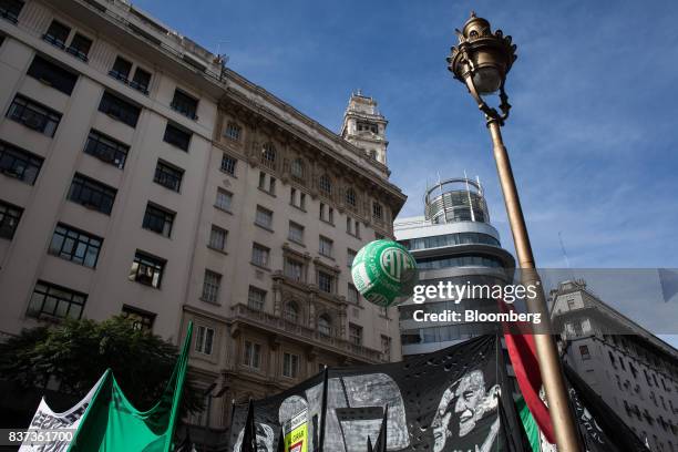 Demonstrators hold signs during a protest in Buenos Aires, Argentina, on Tuesday, Aug. 22, 2017. Union groups protested Argentinean President...