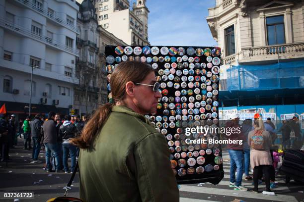 Street vendor sells buttons during a protest in Buenos Aires, Argentina, on Tuesday, Aug. 22, 2017. Union groups protested Argentinean President...