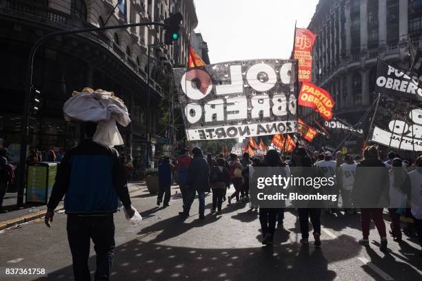 Vendor sells food, left, during a protest in Buenos Aires, Argentina, on Tuesday, Aug. 22, 2017. Union groups protested Argentinean President...