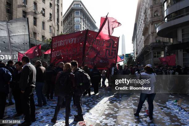 Demonstrators hold signs during a protest in Buenos Aires, Argentina, on Tuesday, Aug. 22, 2017. Union groups protested Argentinean President...