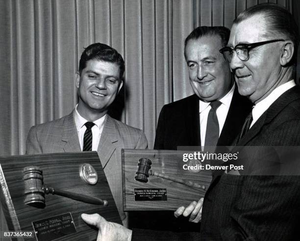 Municipal Memontos Gerald E. McAuliffe , presiding judge of the Denver Municipal Courts, presents plaques bearing the gavels they used when they were...