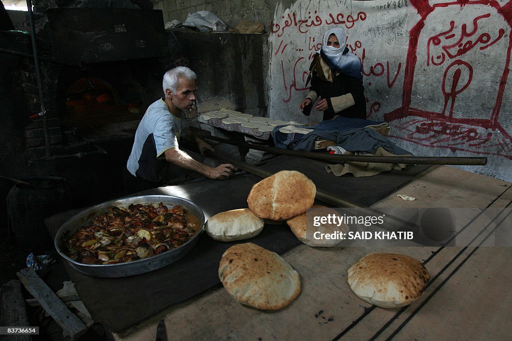 A Palestinian baker removes freshly-bake