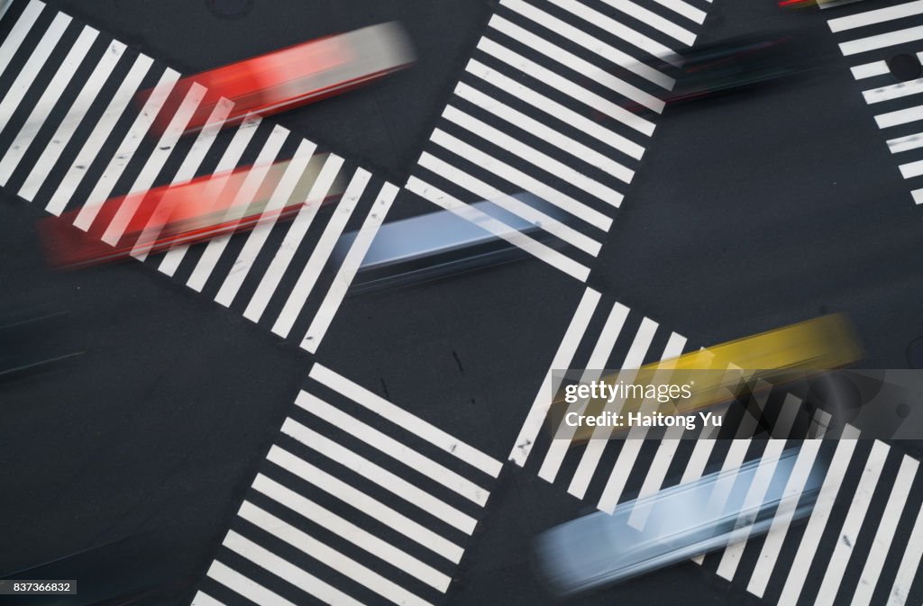 Tokyo. Multi colored taxis crossing zebra lines at Ginza.