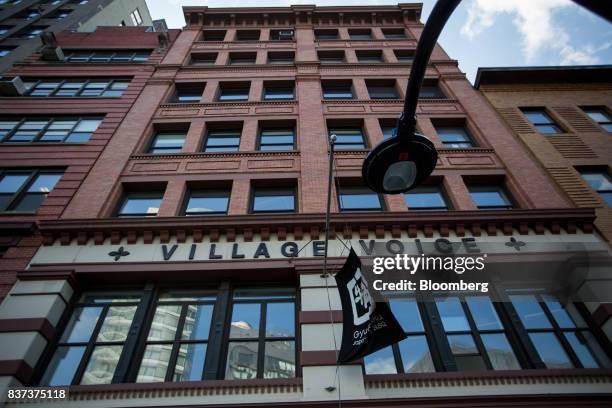 Signage is displayed in front of the former headquarters for The Village Voice in the East Village neighborhood of New York, U.S., on Tuesday, Aug....