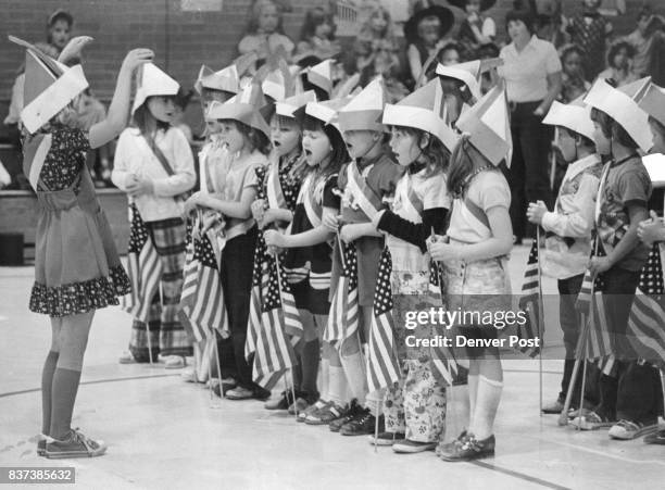 Broomfield's Emerald Elementary School Marks Bicentennial-Centennial Jina Miller directs fellow first graders in several patriotic choral selection...