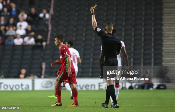 Tom Carroll of Swansea City receives a yellow card during the Carabao Cup Second Round match between MK Dons and Swansea City at StadiumMK on August...