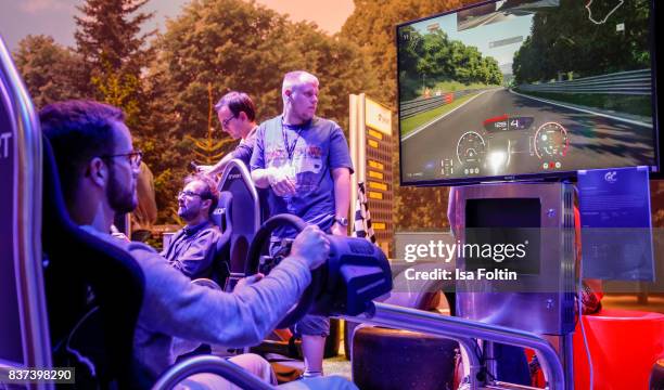 Gaming enthusiasts tries out a racing game at the Gamescom 2017 gaming trade fair on August 22, 2017 in Cologne, Germany. Gamescom is the world's...