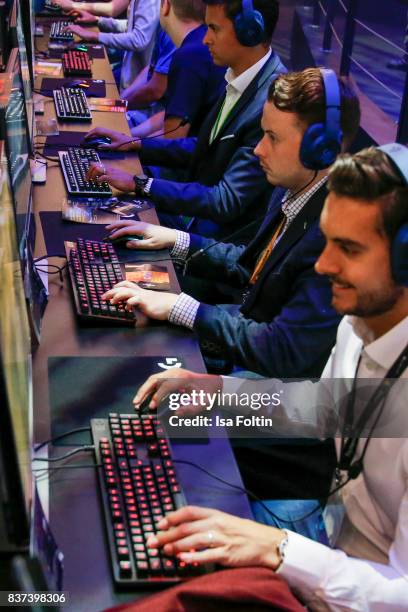 Gaming enthusiasts try out a virtual reality game at the Gamescom 2017 gaming trade fair on August 22, 2017 in Cologne, Germany. Gamescom is the...