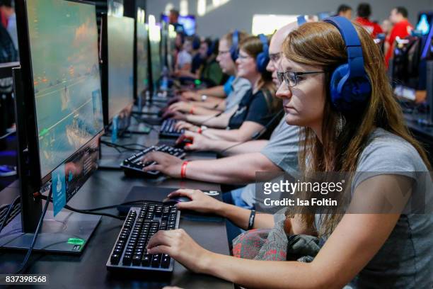 Gaming enthusiasts try out a virtual reality game at the Gamescom 2017 gaming trade fair on August 22, 2017 in Cologne, Germany. Gamescom is the...