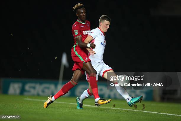 Tammy Abraham of Swansea City and Paul Downing of MK Dons during the Carabao Cup Second Round match between Milton Keynes Dons and Swansea City at...