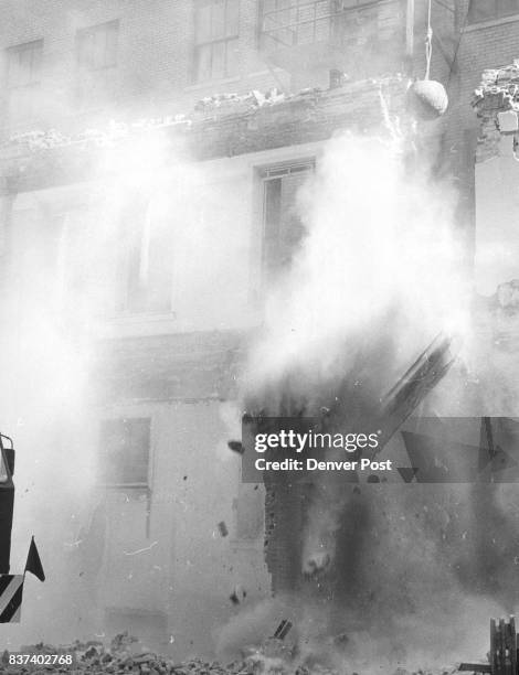 This modern method of razing a thick brick wall is a smash­ing success. After the bridge above the window opening is demolished, remaining uprights...