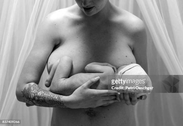 a young woman breastfeeding her newborn baby boy. - mother son milk imagens e fotografias de stock