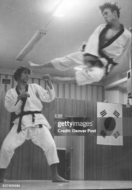 Chris Doubek Executes Jumping Side Kick Dr. William Graham, left, is unruffled practice target. Credit: The Denver Post