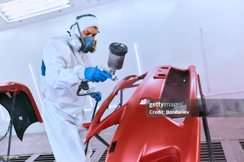 Painting the car's bumper red on the service.