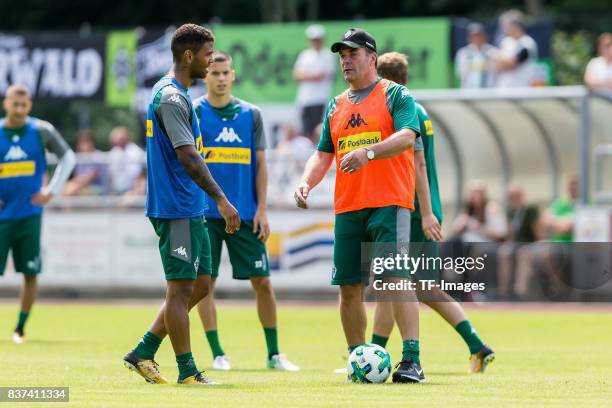 Head coach Dieter Hecking of Borussia Moenchengladbach speak with Kwame Yeboah of Borussia Moenchengladbach during a training session at the Training...