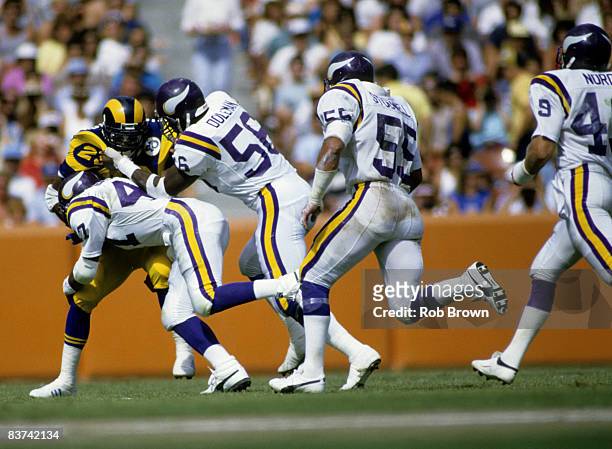 Minnesota Vikings safety Joey Browner and defensive end Chris Doleman stop Rams Hall of Fame running back Eric Dickerson during the Vikings 13-10...