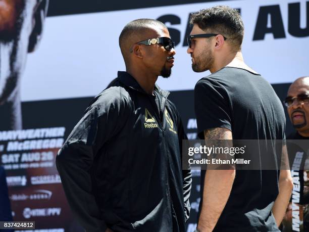 Boxers Badou Jack and WBA light heavyweight champion Nathan Cleverly face off after arriving at Toshiba Plaza on August 22, 2017 in Las Vegas,...