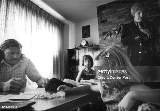 Deputy U.S. Marshal David Neff stands to the right as Newbold explains circumstances surrounding the family's eviction from their home Monday....