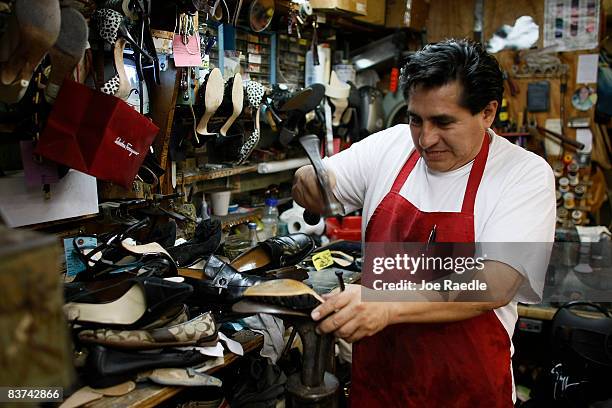 Nicholas Cammarata works on repairing a shoe at Adams Shoe Service Shop November 18, 2008 in Surfside, Florida. Store owner Tina Cammarata say's she...