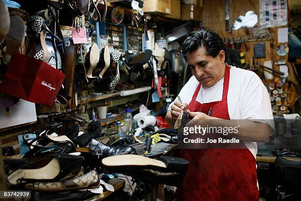 Nicholas Cammarata works on repairing a shoe at Adams Shoe Service Shop November 18, 2008 in Surfside, Florida. Store owner Tina Cammarata say's she...