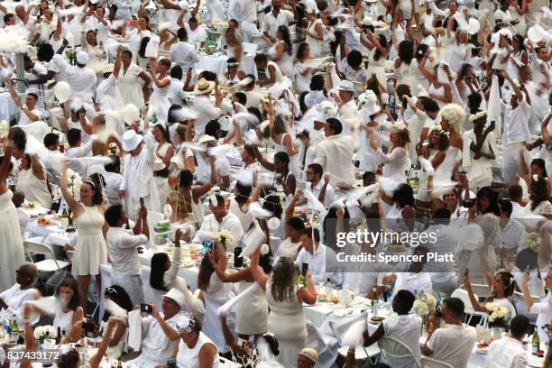 Thousands of diners wave their napkins at the start of the annual "Diner en Blanc" at Lincoln Center on August 22, 2017 in New York City. Diner en...