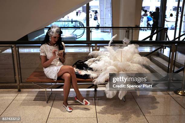 Woman uses her phone before the start of the annual "Diner en Blanc" at Lincoln Center on August 22, 2017 in New York City. Diner en Blanc began in...