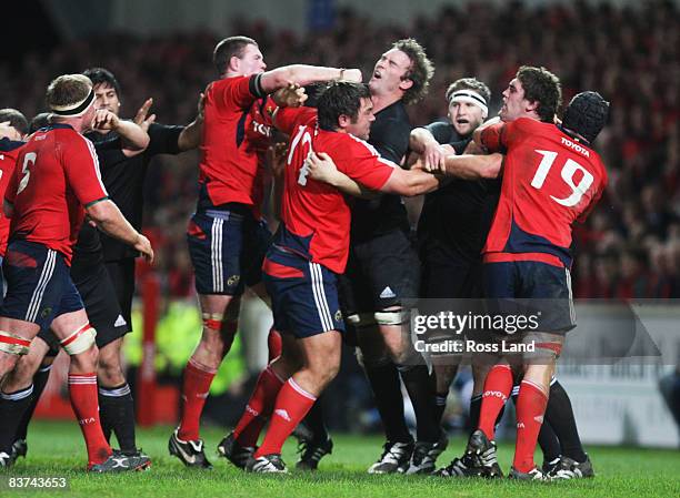 Jason Eaton of the All Blacks is punched in the mouth by Donnacha Ryan of Munster during the Munster V New Zealand All Blacks rugby match at Thomond...