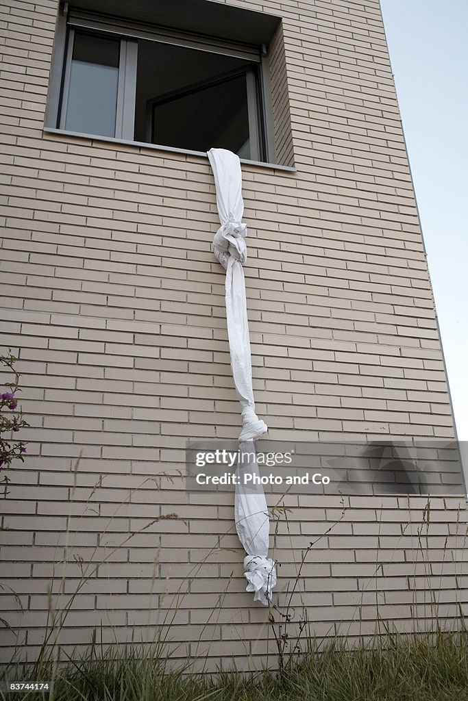 Sheets tied to create a rope out of a window