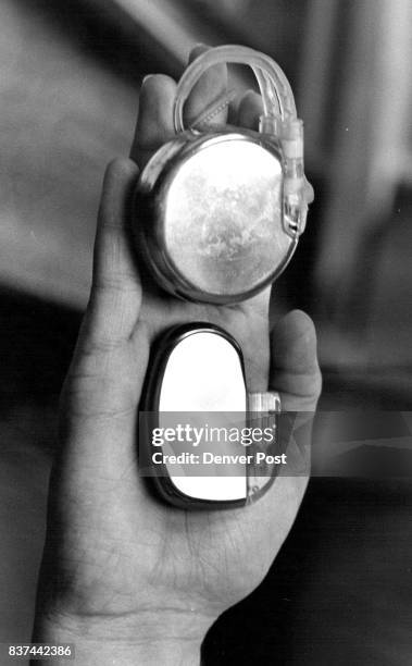 St. Luke's Hosp Dr. Fred Schoonmaker holds old and Current model of pacemaker response -2. Credit: The Denver Post